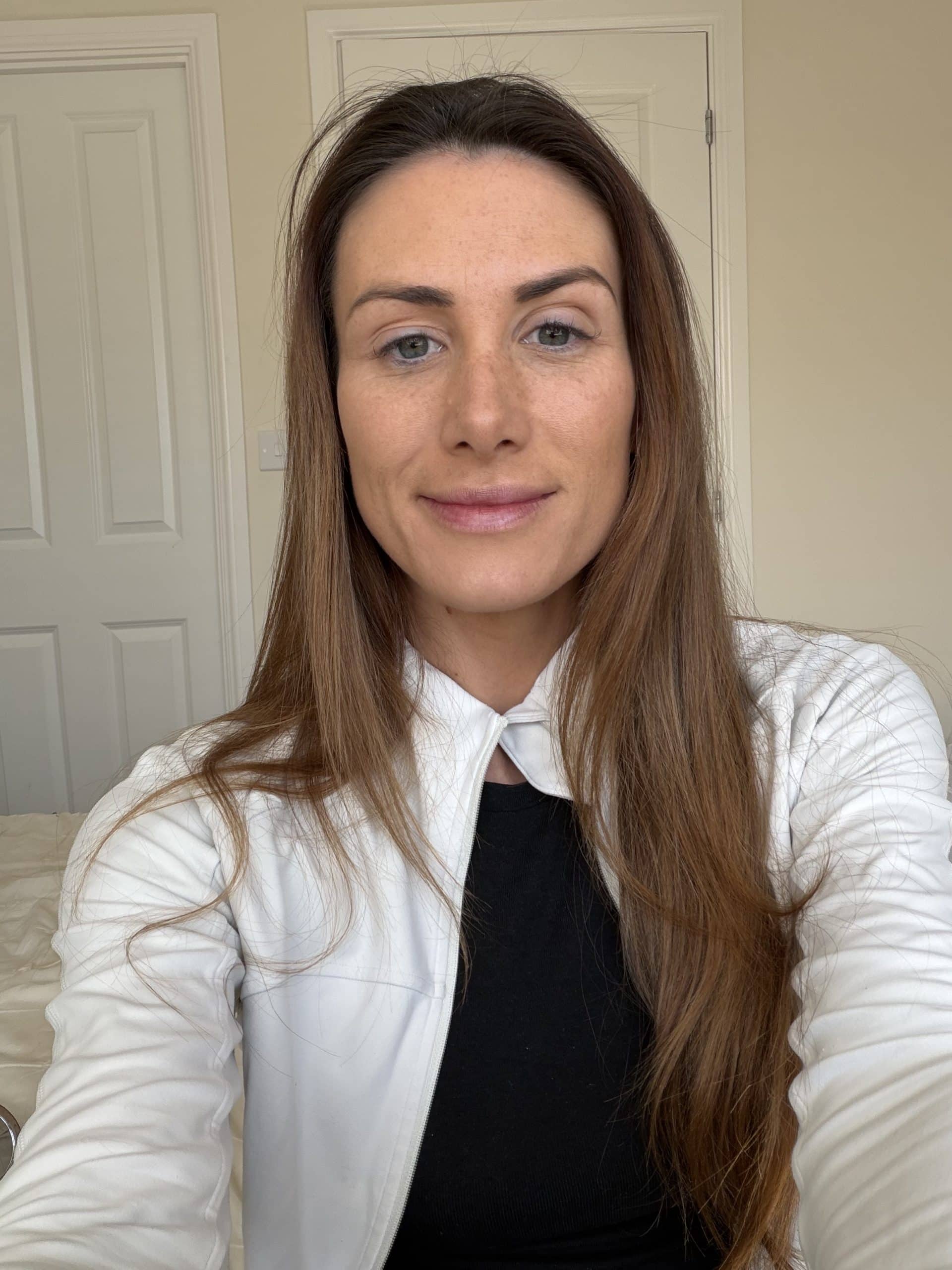 Laura Mercier tinted blur balm on the left hand side of my face and the Charlotte tilbury skin tint stick on the right hand side of my face
